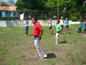 Norlan and Francisco compete in the sack race during